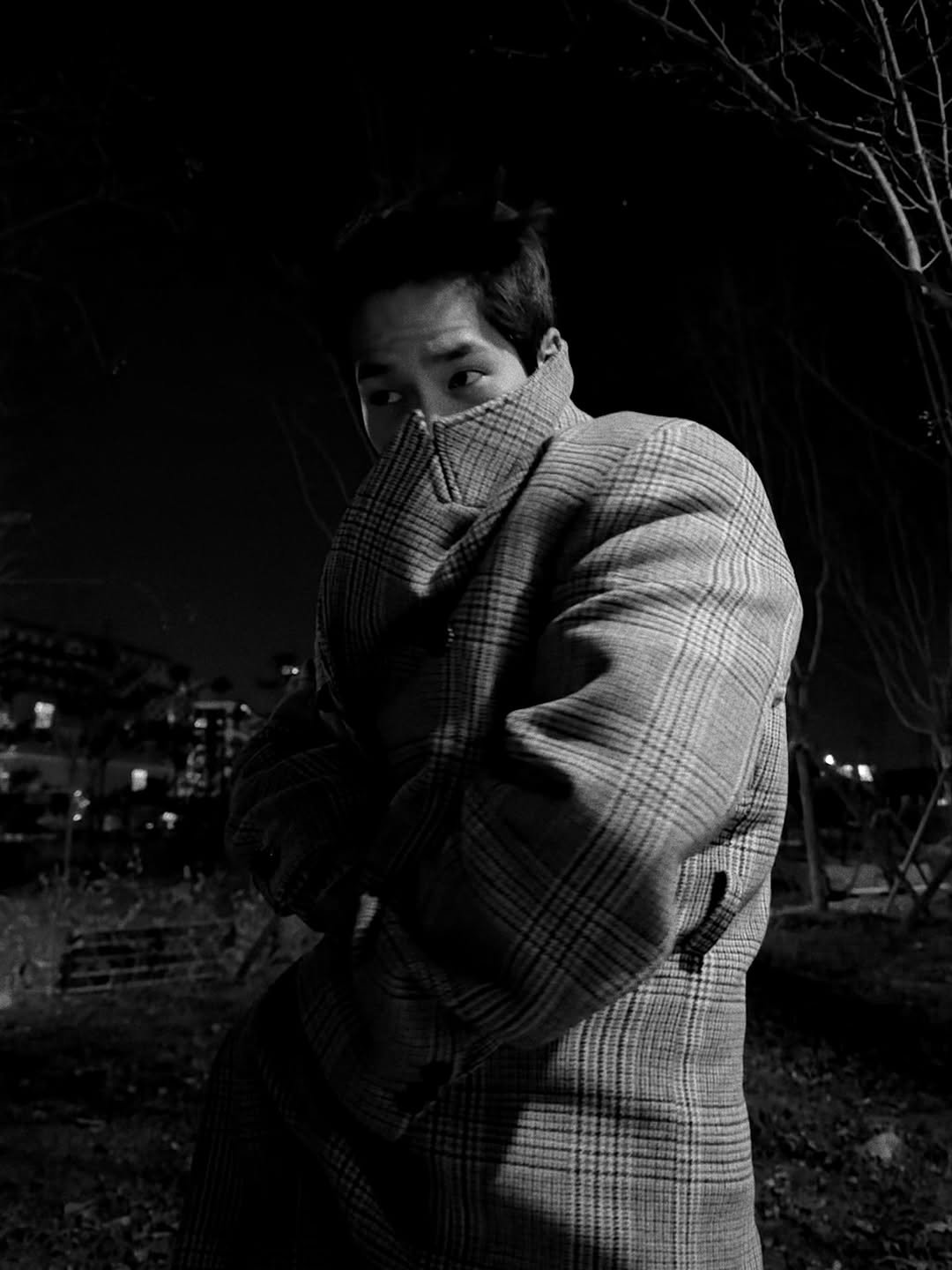 Photo by 육준서 on December 02, 2025. May be a black-and-white image of overcoat, duffle coat, face mask, cigarette and text.