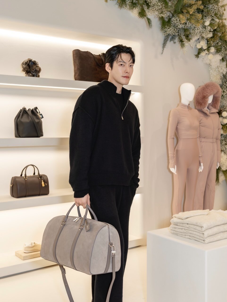 Photo shared by 김우빈 on December 15, 2025 tagging @alo, and @aloseoul. May be an image of sweatpants, briefcase, purse and display case.