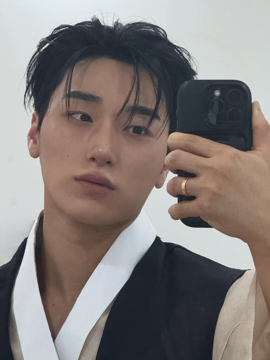 Photo by 산 (SAN) on January 01, 2026. May be an image of one or more people, hair, bolo tie, mirror and text.