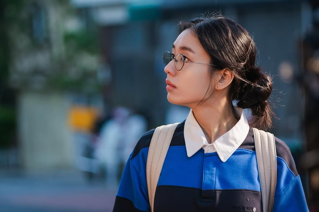 Photo by 안은진 on December 12, 2025. May be an image of one or more people, braids, eyeglasses, street and text.