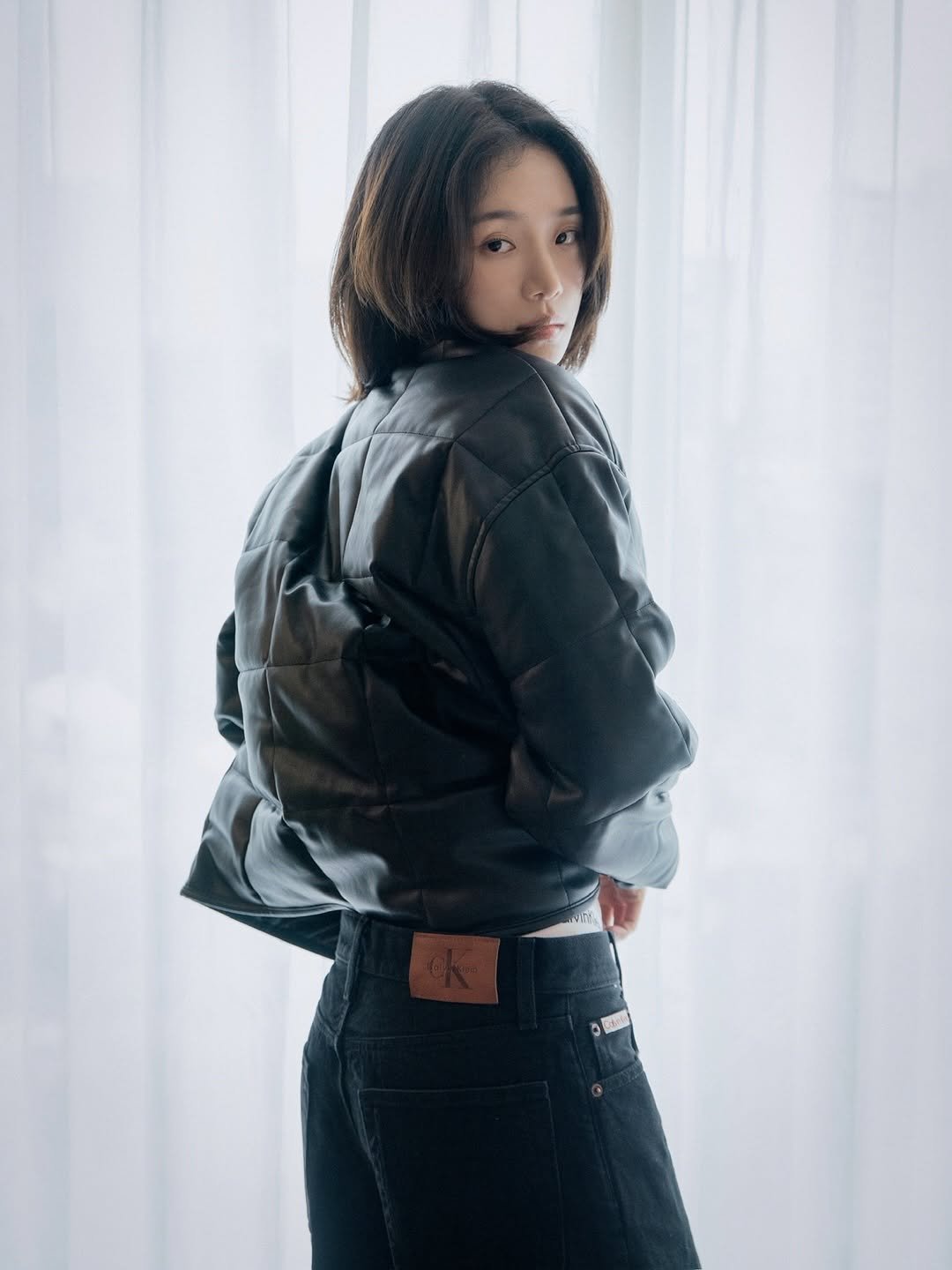 Photo shared by 박규영 on October 17, 2025 tagging @calvinklein. May be an image of goosedown coat, duffle coat, parka, military uniform, flight jacket and text.