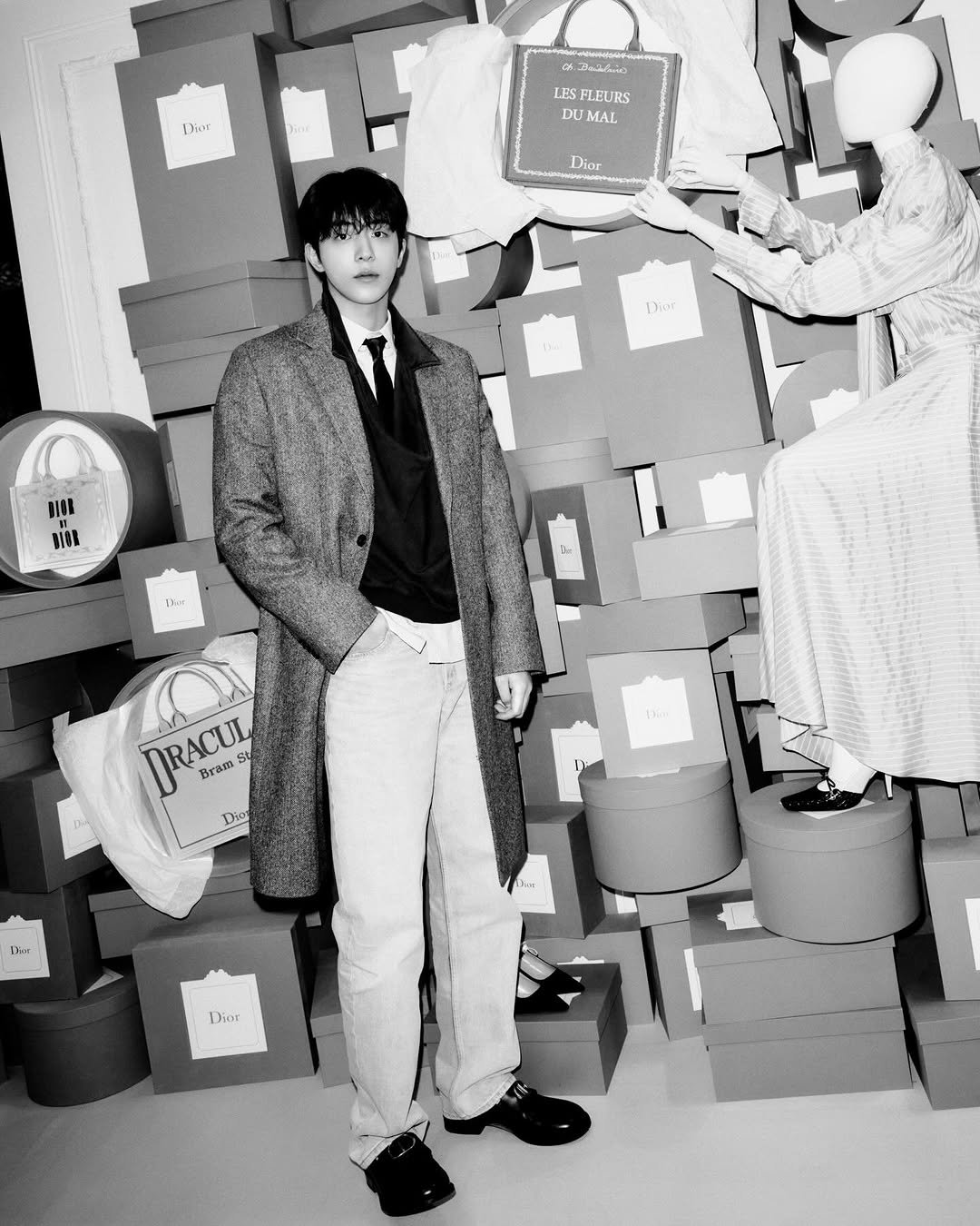 Photo shared by 남주혁 on January 12, 2026 tagging @dior. May be a black-and-white image of one or more people, bangs, overcoat, blazer, bolo tie, suit, top and text that says 'Diệr LJS SFLEL FLEURS DU DUMAL Dior Dior ne DISK BIOK Da: L RACUL RACUL St Bram Dio EЛo Dani Ahur Dior'.