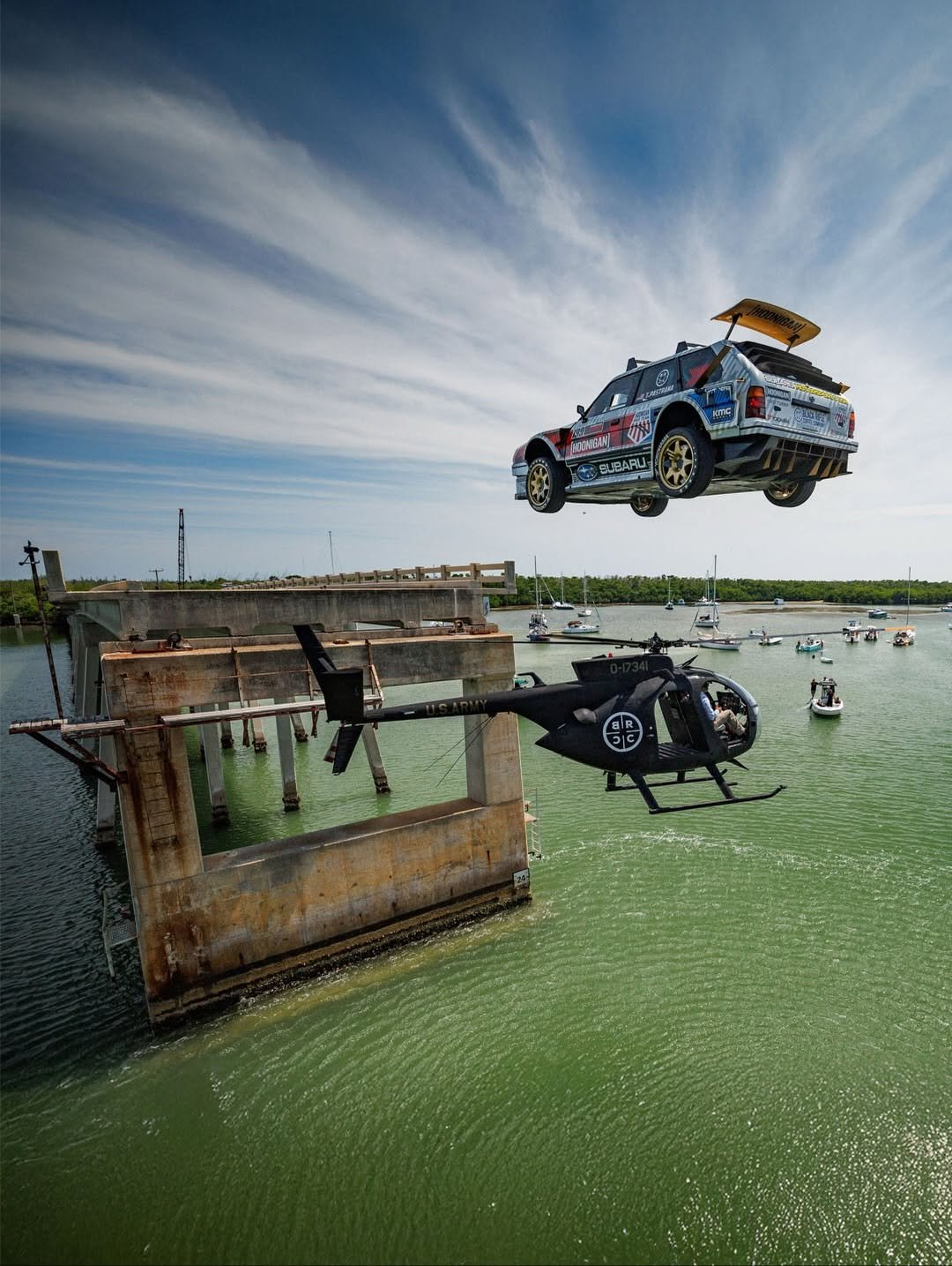 Photo shared by Hoonigan Industries on November 24, 2025 tagging @travispastrana, @subarumotorsportsusa, @kmcwheels, and @yokohamatire. May be an image of helicopter, jet ski, parachute, speedboat, crane and text.