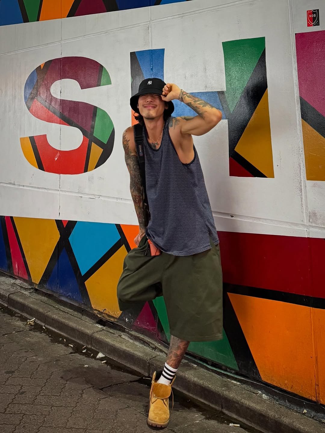 Photo shared by 비 르 on July 24, 2025 tagging @virstyle.kr. May be an image of 1 person, wingtip shoes, hat, shorts, tanktop, kilt and text that says 'SM 除 S a'.