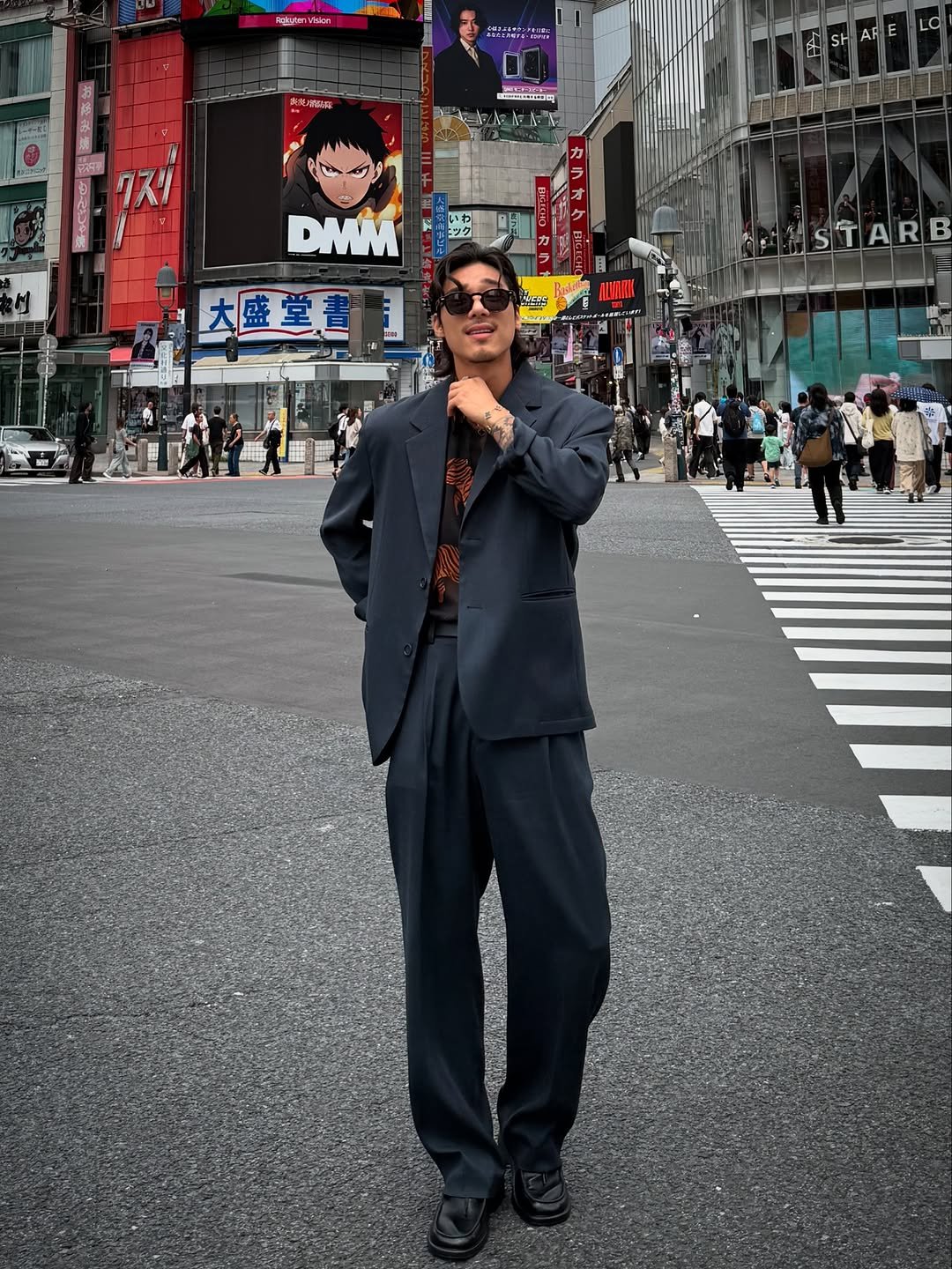 Photo shared by 비 르 on June 13, 2025 tagging @virstyle.kr. May be an image of 12 people, suit, street, Times Square and text.