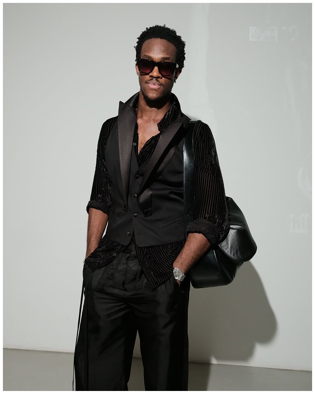 Photo shared by Wisdom Kaye on May 15, 2025 tagging @riotdownn. May be an image of 1 person, leather, suit, blazer, dinner jacket and text.