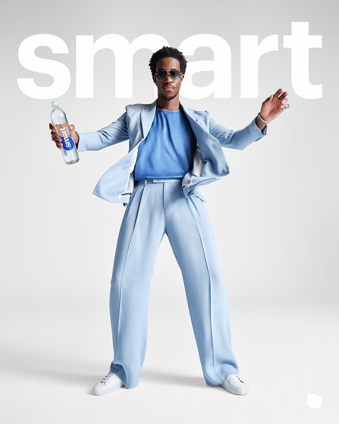 Photo shared by smartwater on May 13, 2025 tagging @wisdm, and @smartwater. May be an image of 1 person, eyewear, magazine, poster, suit and text that says '55 snoart art sm'.